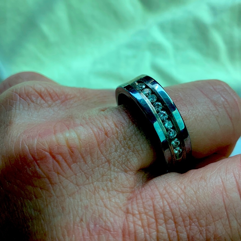 Men’s titanium wedding band ring featuring channel of diamonds
